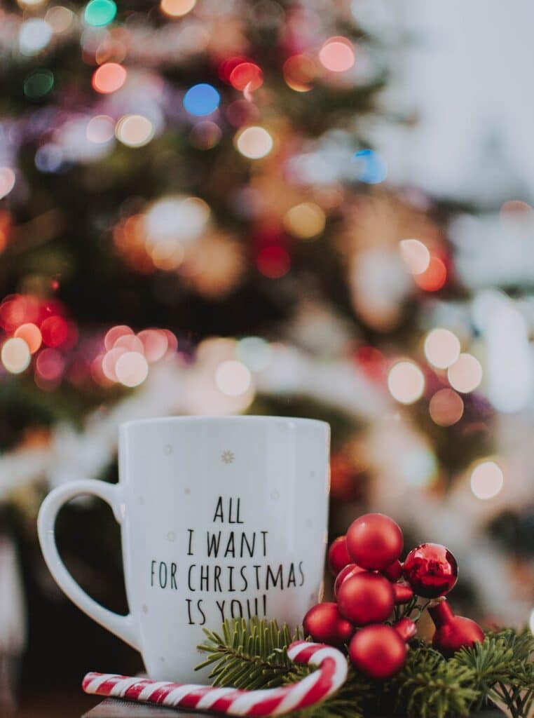 selective focus photography of ceramic mug near candy cane